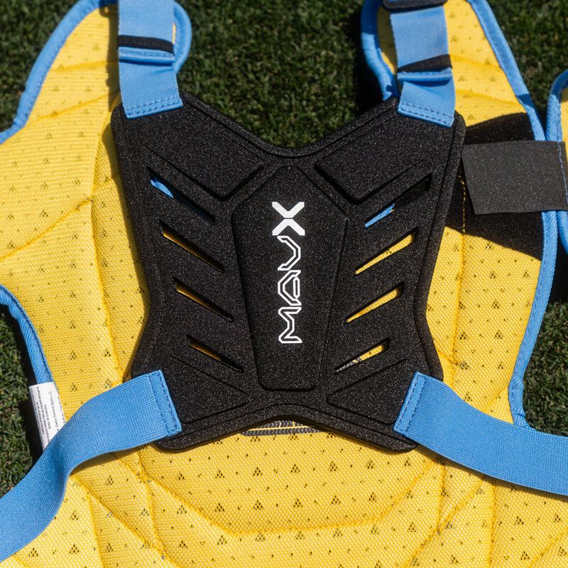 Close-up of black Mavrix chest protector back plate with light blue straps against yellow padding